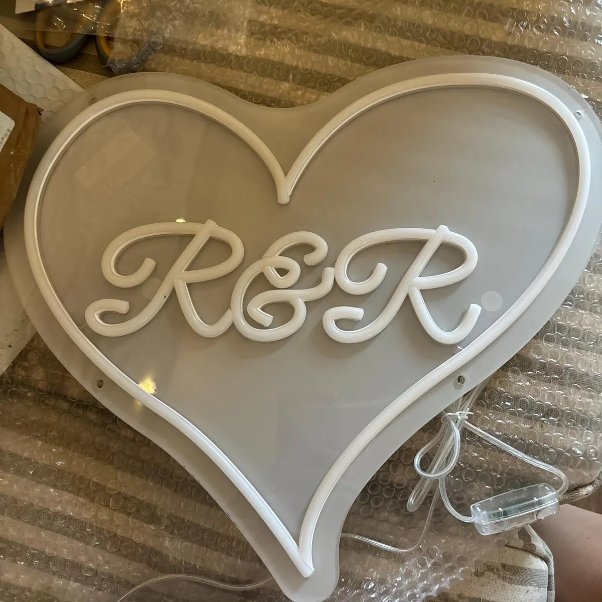 Kate & Richard wedding neon sign review - Say It Bright Kate and Richard's personalised heart neon sign with initials K & R - white warm neon in heart shape